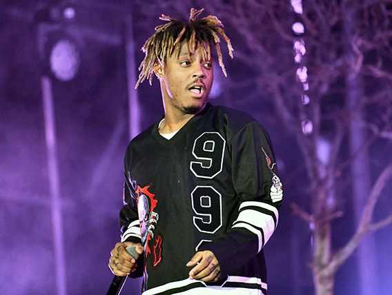 Close-up photo of Juice WRLD with purple background