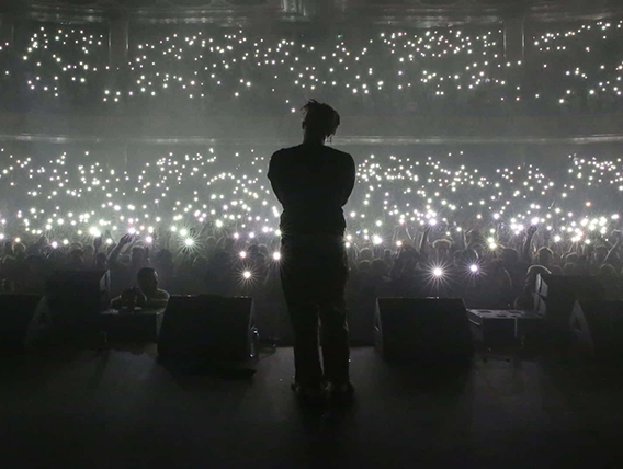 Juice WRLD on stage with cheering audience