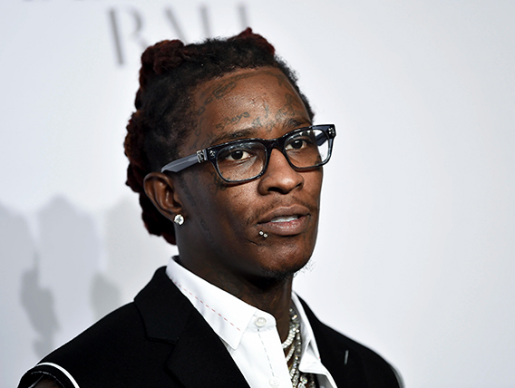 Young Thug performing under stage lights